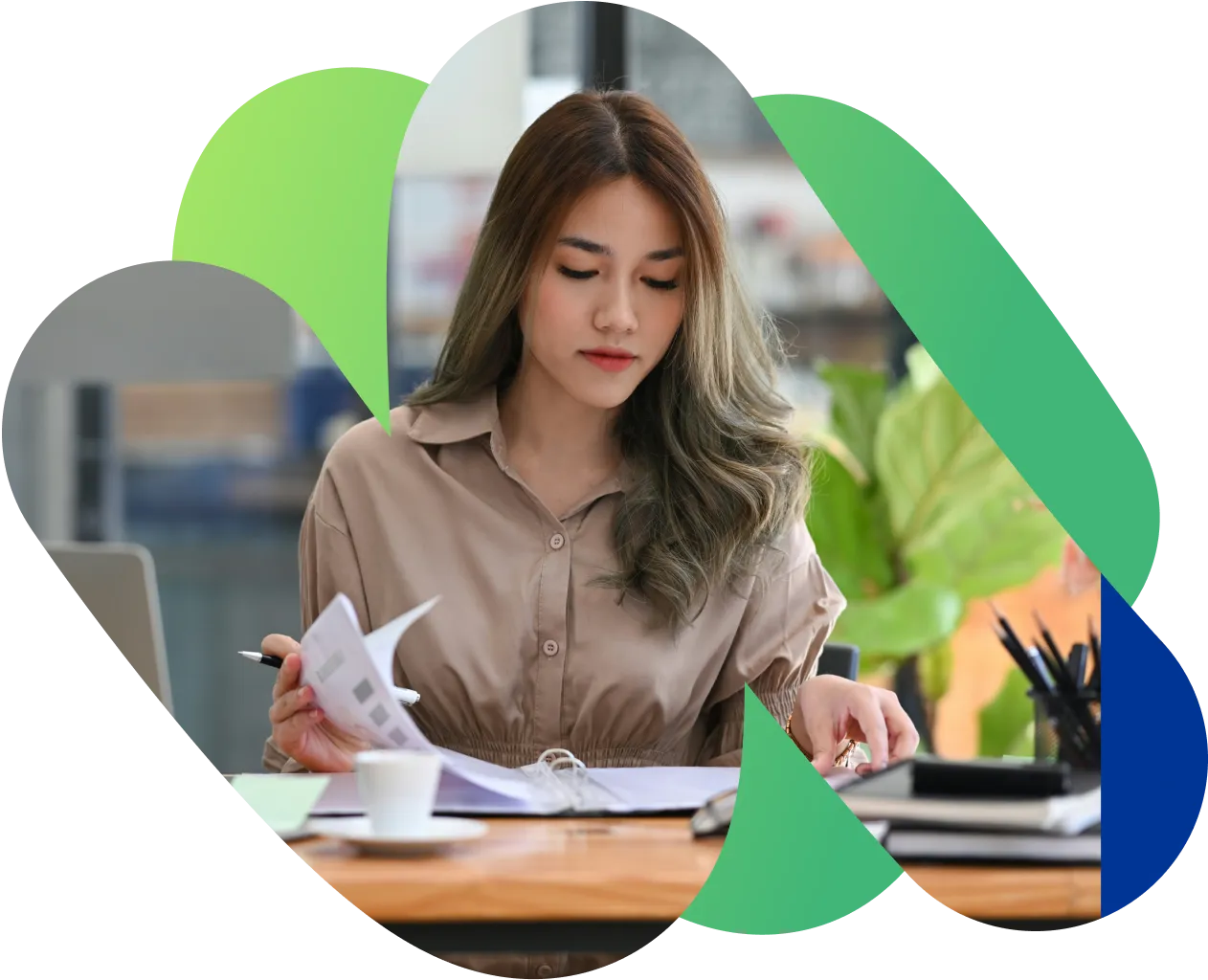 A freelancer working through paperwork at her desk.